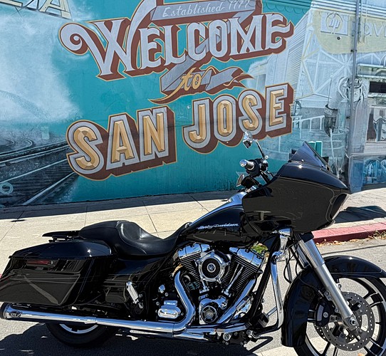 Detailed Harley-Davidson bagger in front of the Welcome to San Jose mural